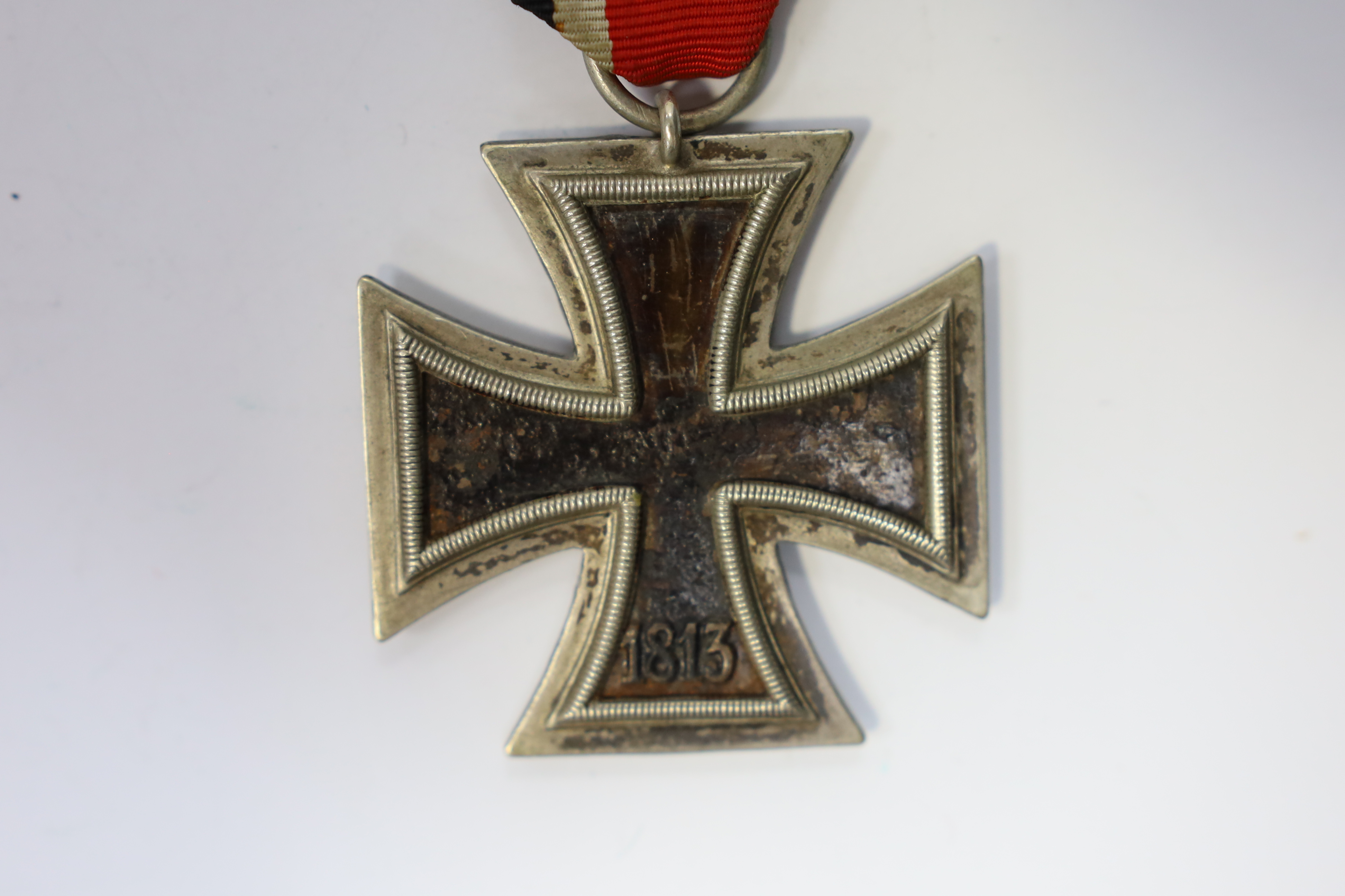 A WWII Iron Cross. Condition - poor, black paint now mainly missing from surface.